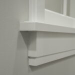 Detail van witte muur en raamkozijn