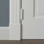 Witte deur met scharnier op houten vloer.