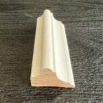 Decoratieve witte houten plint op donkere achtergrond