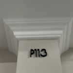 Architecturale zuil met nummer P113 in reliëf