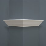 Witte hoekplank op grijze muur.